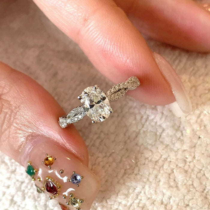 Sterling silver Éclat 1CT moissanite oval solitaire ring showcasing a sparkling oval-cut moissanite gemstone set in a sleek band.