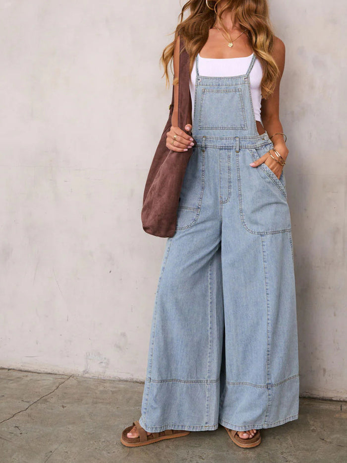 Relaxed fit wide-leg denim overalls from Trendsi, featuring adjustable straps and front pockets, styled on a model.