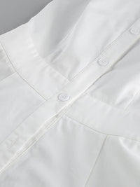 Backless button-front maxi dress from Trendsi featuring a flowing silhouette and elegant design, shown on a model.