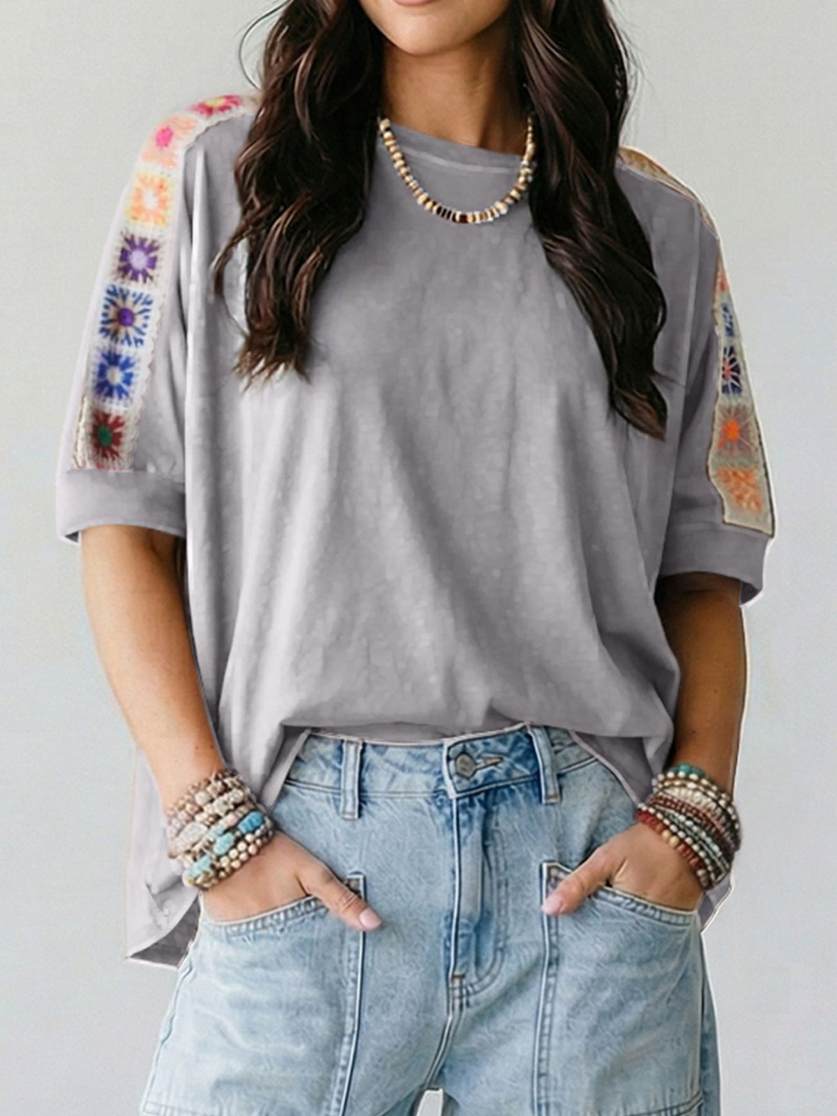 Square crochet detail loose T-shirt from Trendsi, featuring a relaxed fit with textured crochet accents on the blouse.