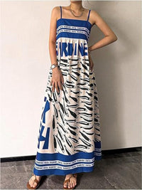 Sardine print spaghetti strap maxi dress from Trendsi featuring a flowy silhouette and colorful fish pattern.