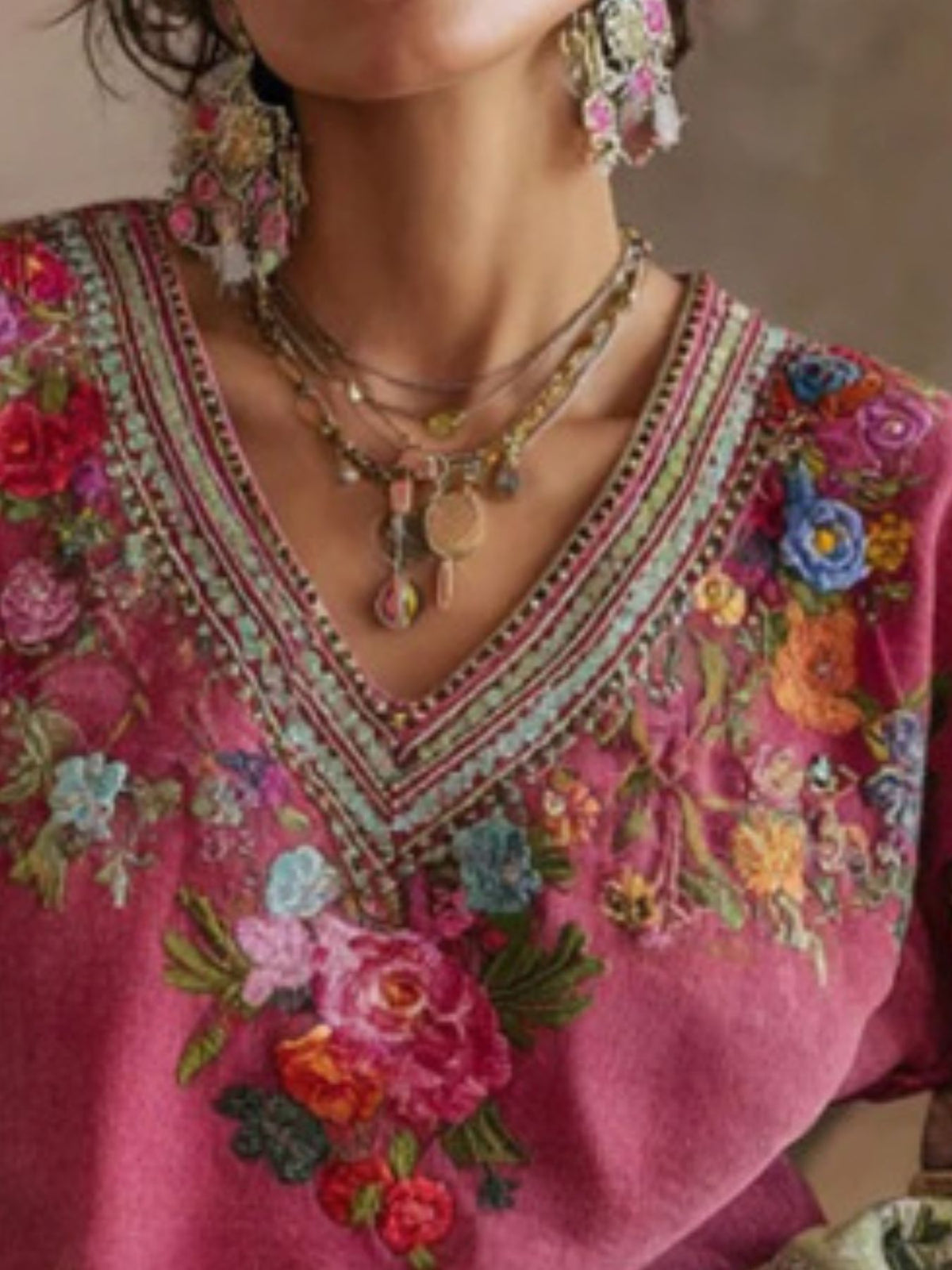 Floral embroidered V-neck blouse from Trendsi, featuring colorful flower patterns on lightweight fabric.