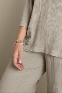 Beaded Cressa bracelet set by SAACHI featuring multiple colorful beaded bracelets on a display.