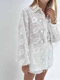 Floral embroidered shirt and shorts set by Trendsi, featuring a matching two-piece summer outfit with colorful floral designs.