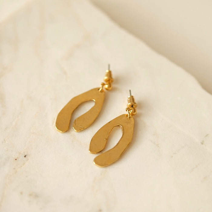 Tillydoro inlet earrings featuring elegant gold hoops with intricate detailing, displayed against a neutral background.