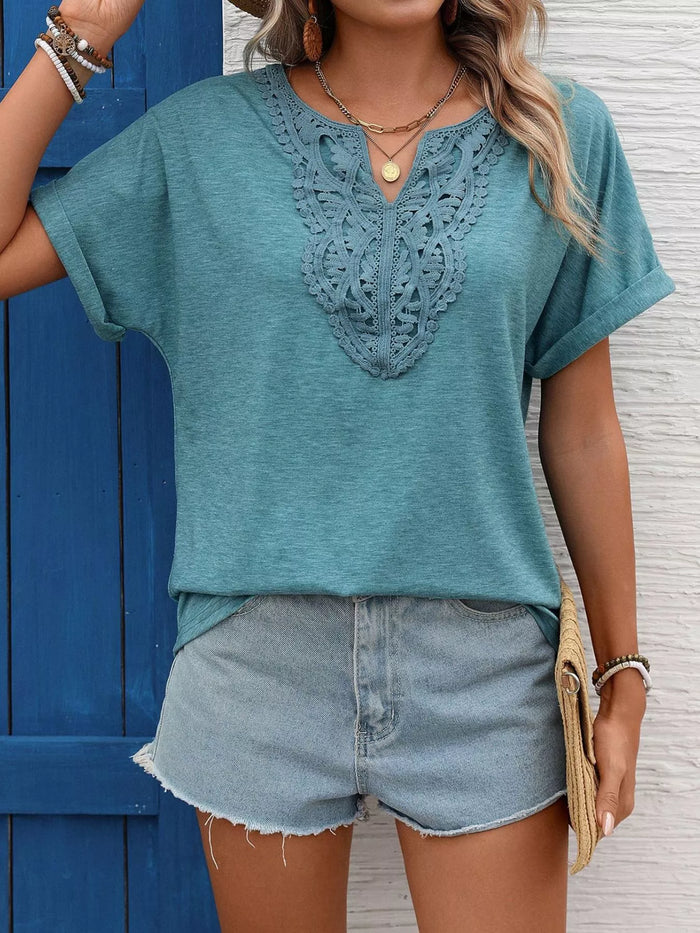 Lace trim short sleeve blouse from Trendsi featuring a feminine design with lace accents, perfect for casual or dressy wear.