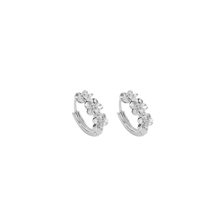 Sterling silver hoop earrings with a smooth, polished finish, styled as trendy jewelry for everyday wear.