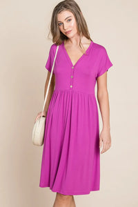 V-neck button front dress from Trendsi, featuring a stylish design, long sleeves, and a flattering fit in soft fabric.