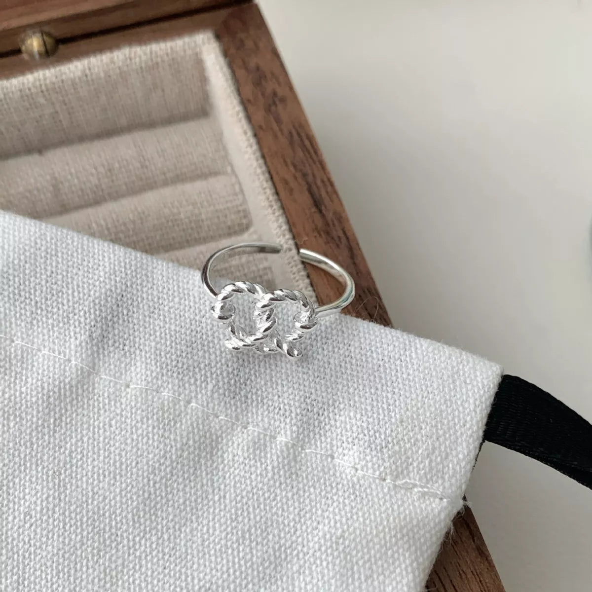 Eternal Knot Heart Ring by Trendsi featuring a silver band with an intricate heart-shaped knot design for elegant jewelry.