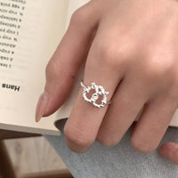 Eternal Knot Heart Ring from Trendsi featuring a silver band with an intricate heart-shaped knot design.
