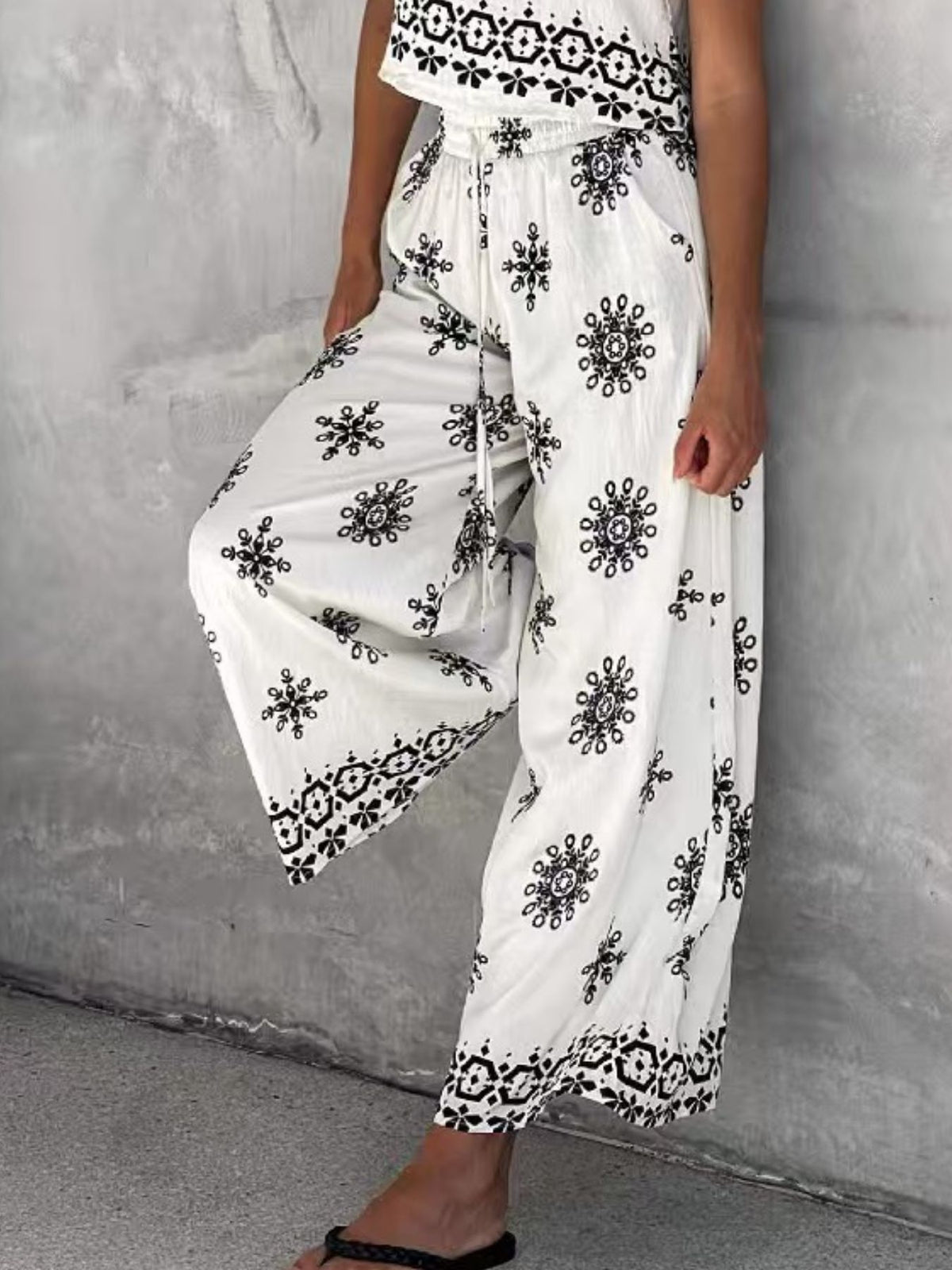 Trendsi sleeveless top and wide leg pants two-piece set shown in a stylish casual outfit on a model.