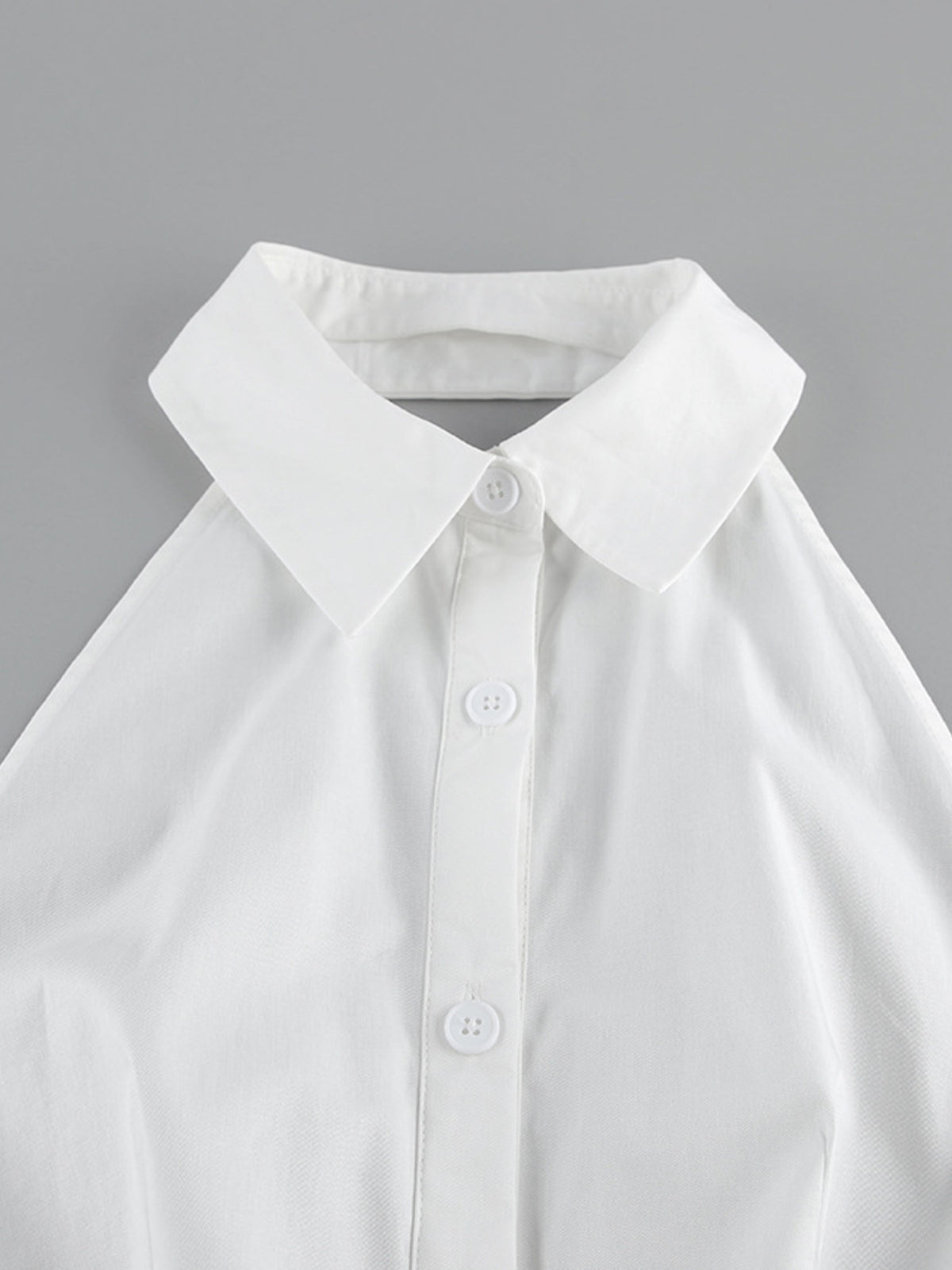 Backless button-front maxi dress from Trendsi featuring a flowing silhouette and stylish design, perfect for elegant occasions.