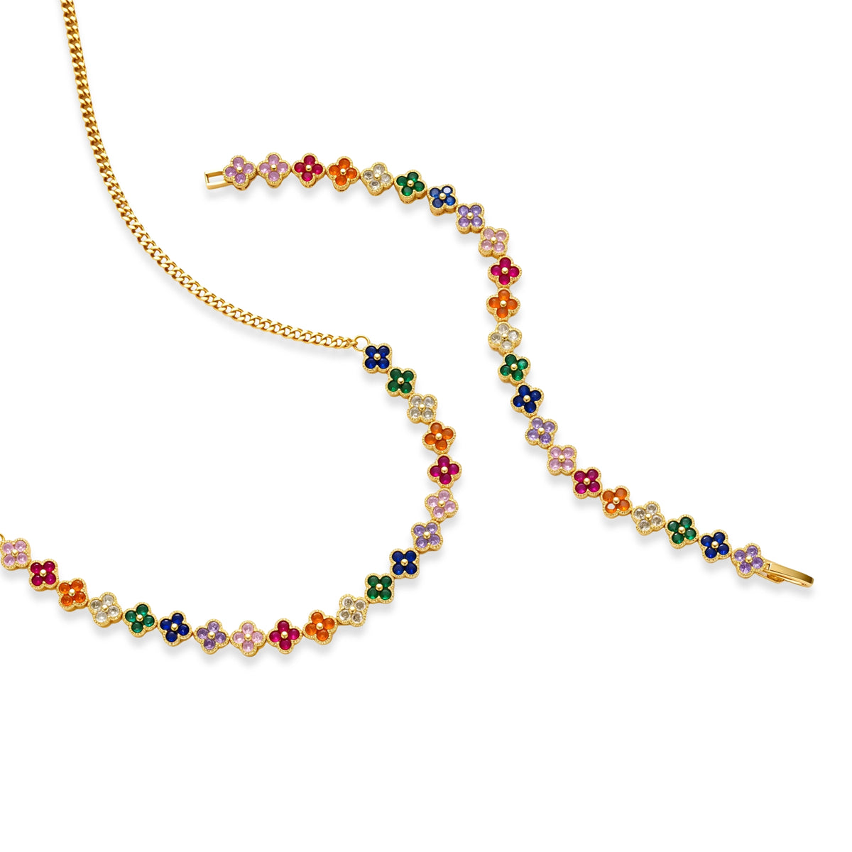 Colorful four-leaf clover jewelry set with rainbow cubic zirconia stones in gold-plated setting on white background