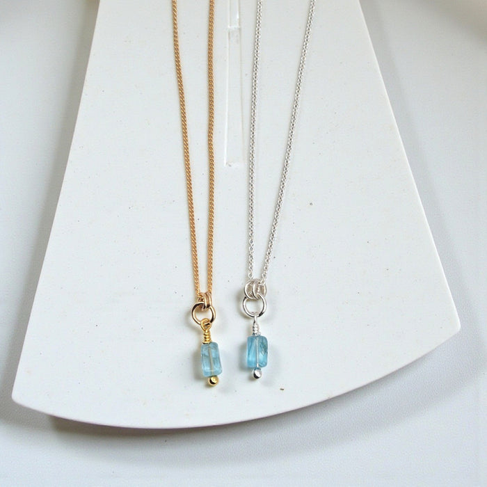 Blue Apatite necklace with silver or gold chain from Bijou by SAM, featuring a polished blue gemstone pendant.