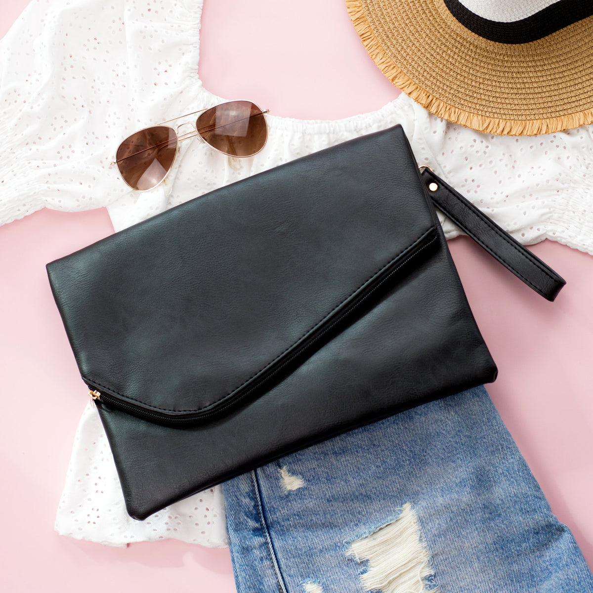 Black Aili's Corner foldover envelope clutch handbag with sleek design and minimalistic style.