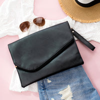 Black Aili's Corner foldover envelope clutch handbag with sleek design and minimalistic style.