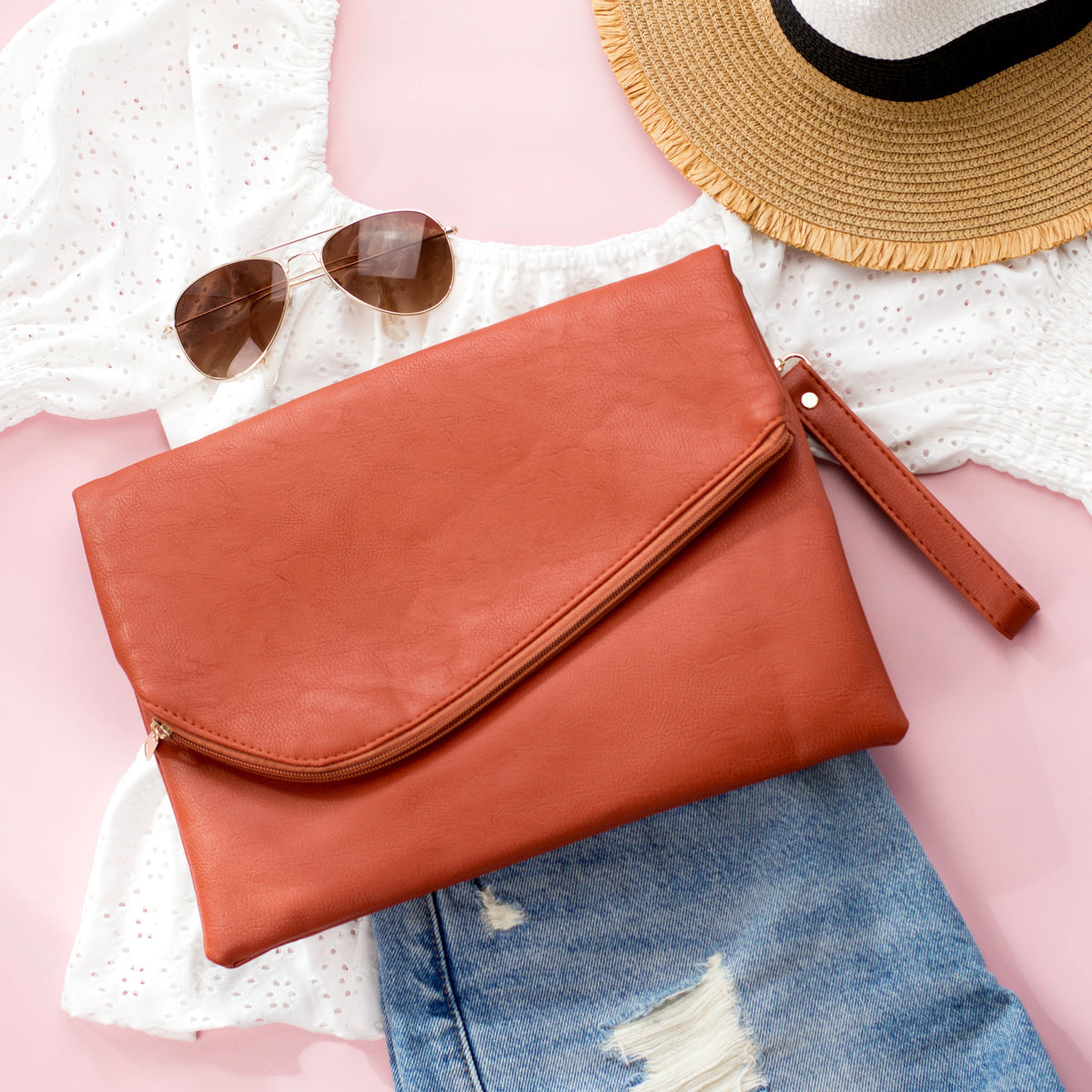 Aili's Corner burnt sienna foldover envelope clutch handbag with sleek design and smooth leather finish.
