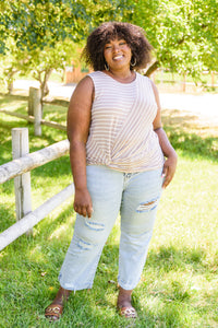 A woman wearing the Ella Striped Tank top from Ave Shops, featuring horizontal stripes and a casual sleeveless design.