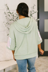 Cable ribbed knit hooded blouse by Ave Shops featuring a cozy, fitted design with a front pocket and long sleeves.