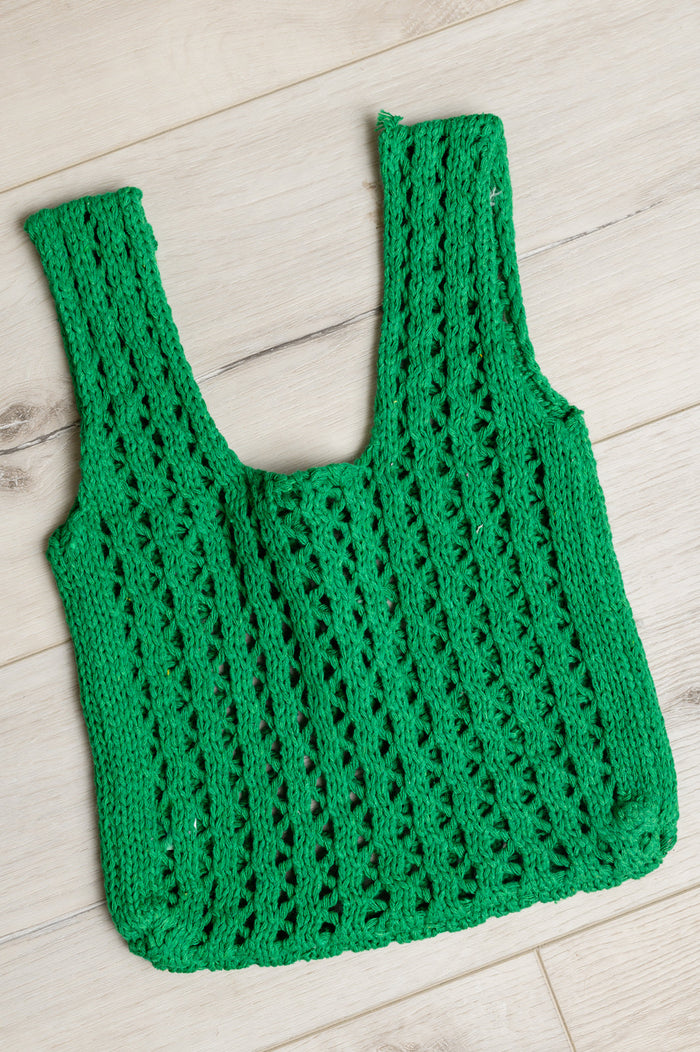 Green open weave handbag for girls, styled as a trendy accessory, featuring a spacious design and woven texture.