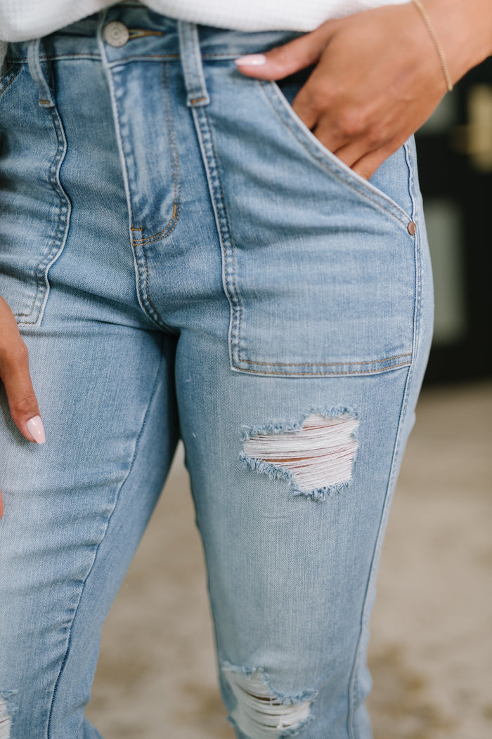 Aiden high rise distressed boyfriend jeans with patch pockets from Ave Shops, featuring a relaxed fit and faded denim style.