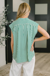 Green women's sleeveless V-neck blouse by Ave Shops, stylish and lightweight top with a relaxed fit and elegant design.