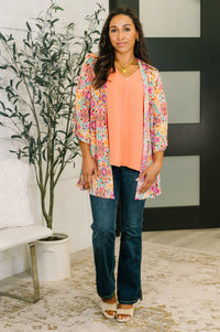 Pink and orange floral abstract Lizzy cardigan by Ave Shops, showcasing a stylish knit with vibrant floral patterns.