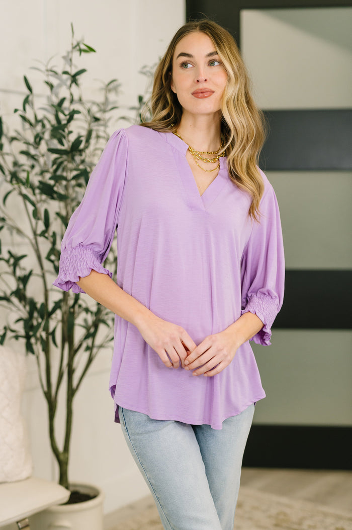 Lizzy Smock Top in Orchid Bloom, a stylish blouse with floral print and relaxed fit, perfect for casual or semi-formal wear.