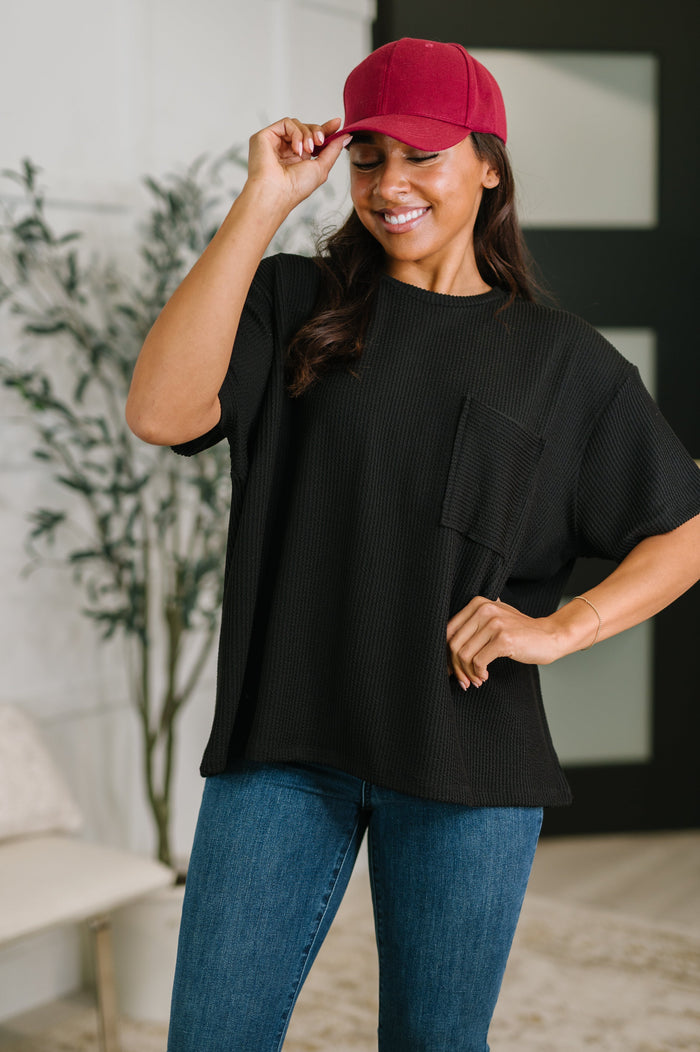 Black textured boxy tee from Ave Shops, showcasing a relaxed fit blouse with a subtle pattern and short sleeves.