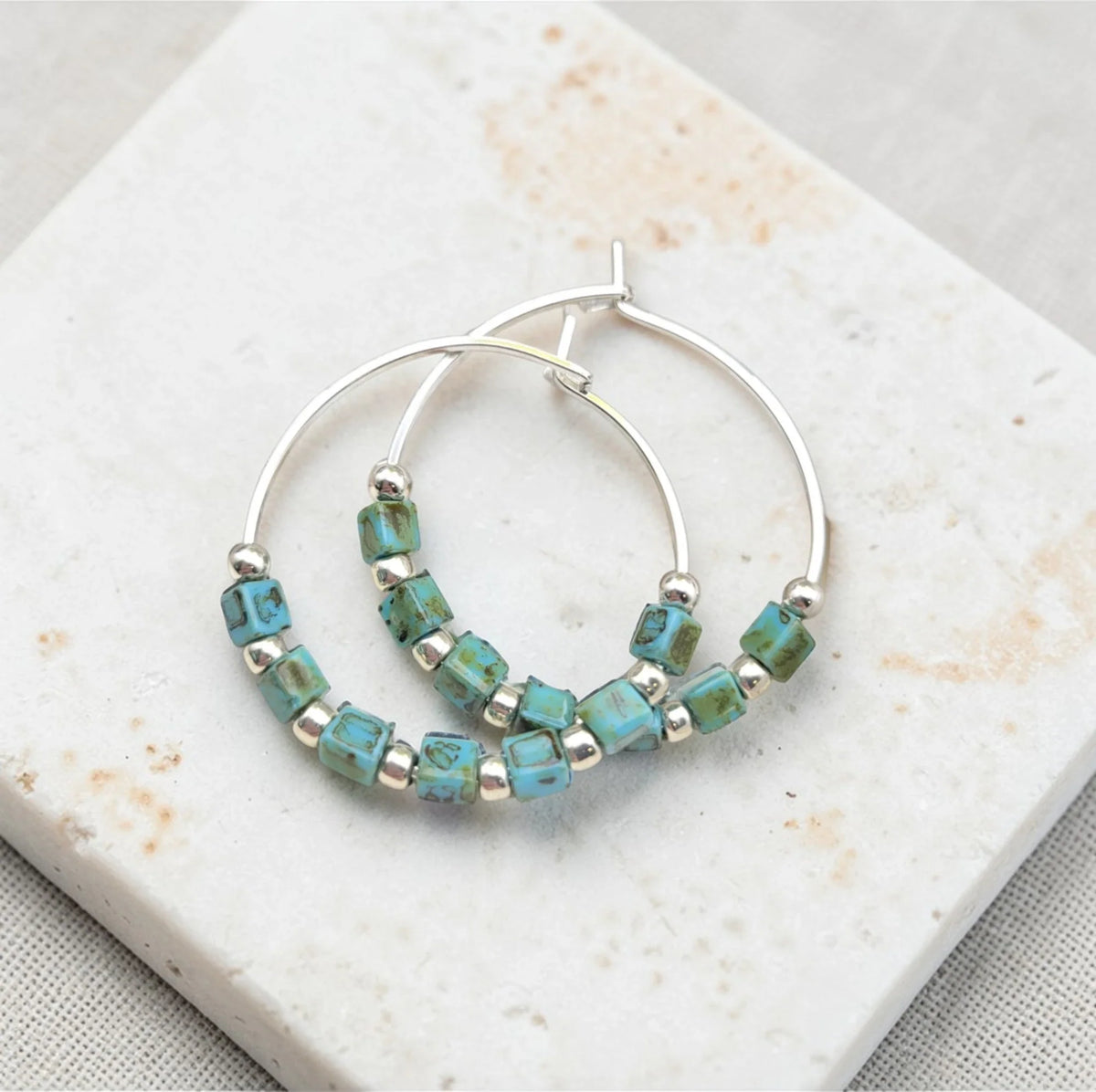 Silver and turquoise beaded hoop earrings from Bijou by SAM featuring boho-style silver and turquoise jewelry.