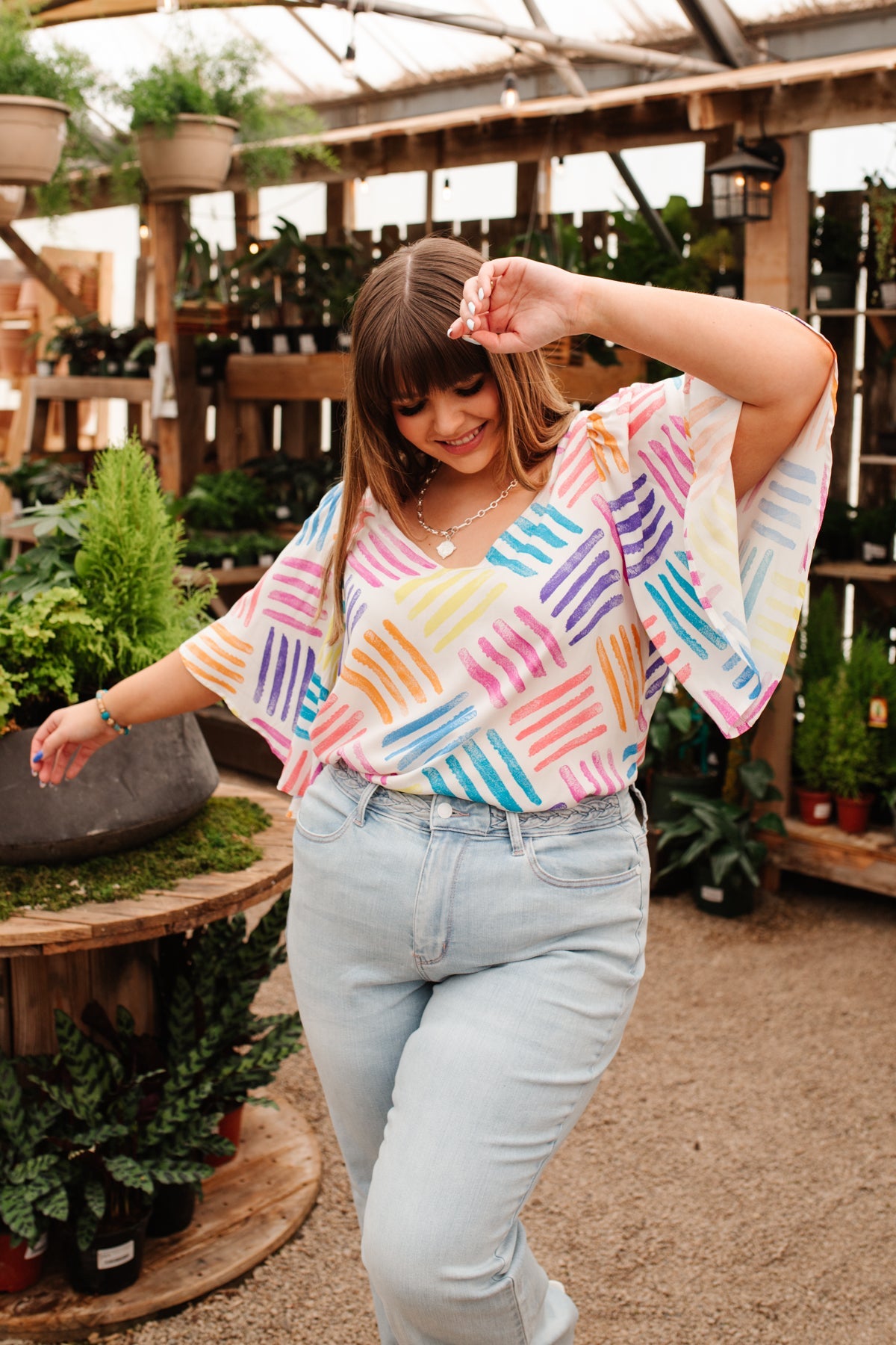 Light-colored Stamped By Love blouse from Ave Shops with a floral embroidered design, showcasing a casual, stylish shirt for women.