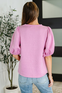 Blusa texturizada con mangas globo en color rosa