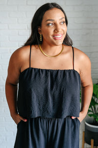 Black spaghetti strap jumpsuit from Ave Shops, featuring a fitted bodice and wide-leg pants, perfect for casual or dressy occasions.