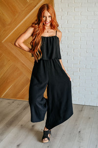 Black spaghetti strap jumpsuit by Ave Shops, featuring a fitted bodice and wide-leg pants, perfect for casual or semi-formal occasions.