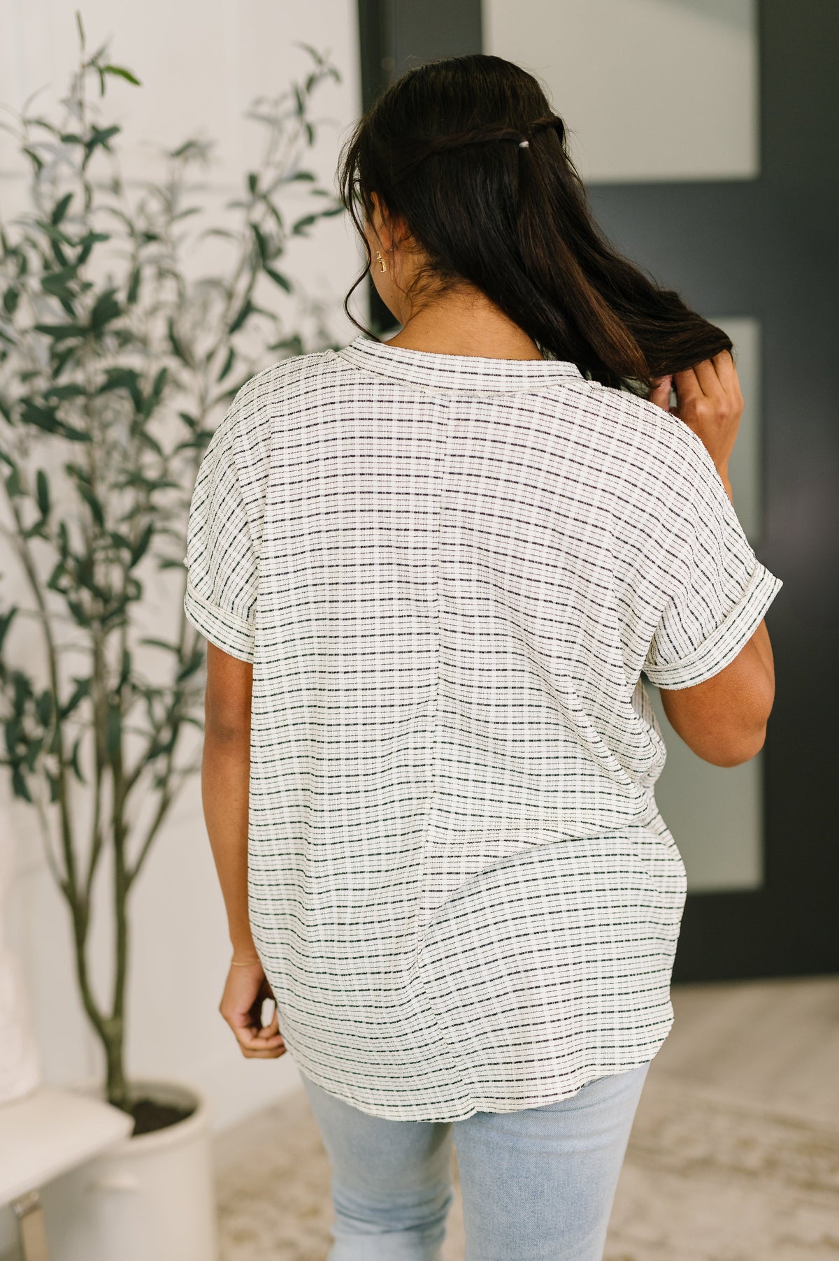 Light blue You Just Get It V-Neck Top by Ave Shops, shown on a hanger, featuring a soft V-neck and relaxed fit blouse.