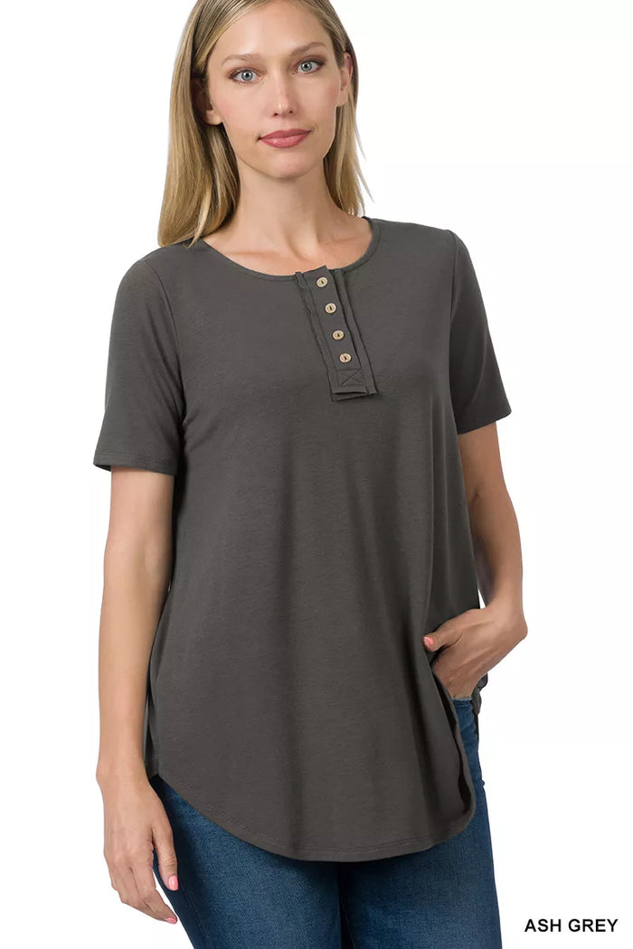 Zenana short sleeve button-down blouse from Trendsi, featuring a classic collar, front buttons, and a relaxed fit.