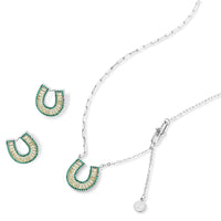 Sparkling horseshoe-shaped jewelry set with AAA cubic zirconia in gold-plated and white gold finishes on cream background.