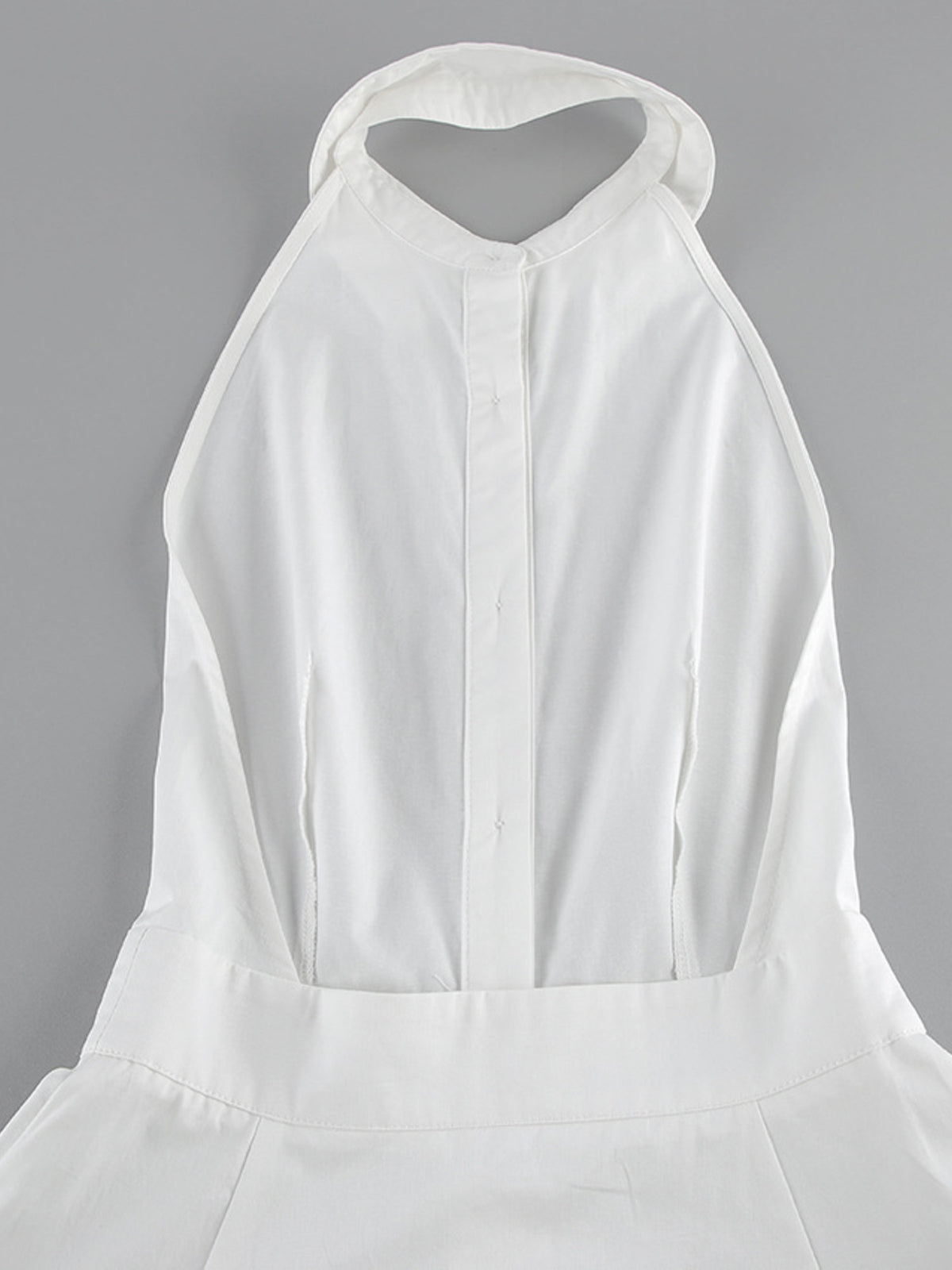 Backless button-front maxi dress by Trendsi featuring a flowing silhouette and open back, perfect for elegant summer occasions.