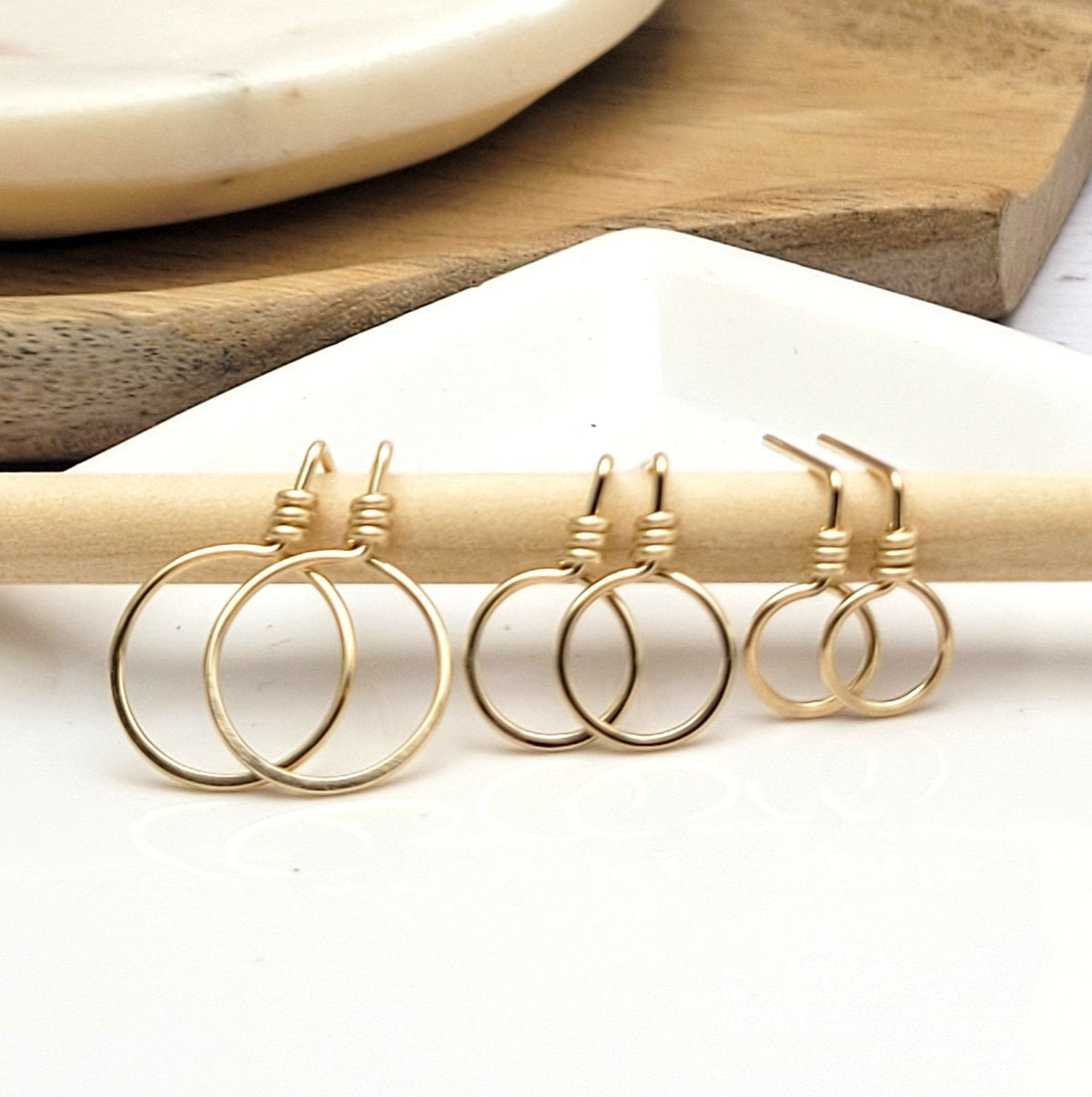 Small gold circle stud earrings by Bijou by SAM, featuring minimalist round design perfect for everyday wear.