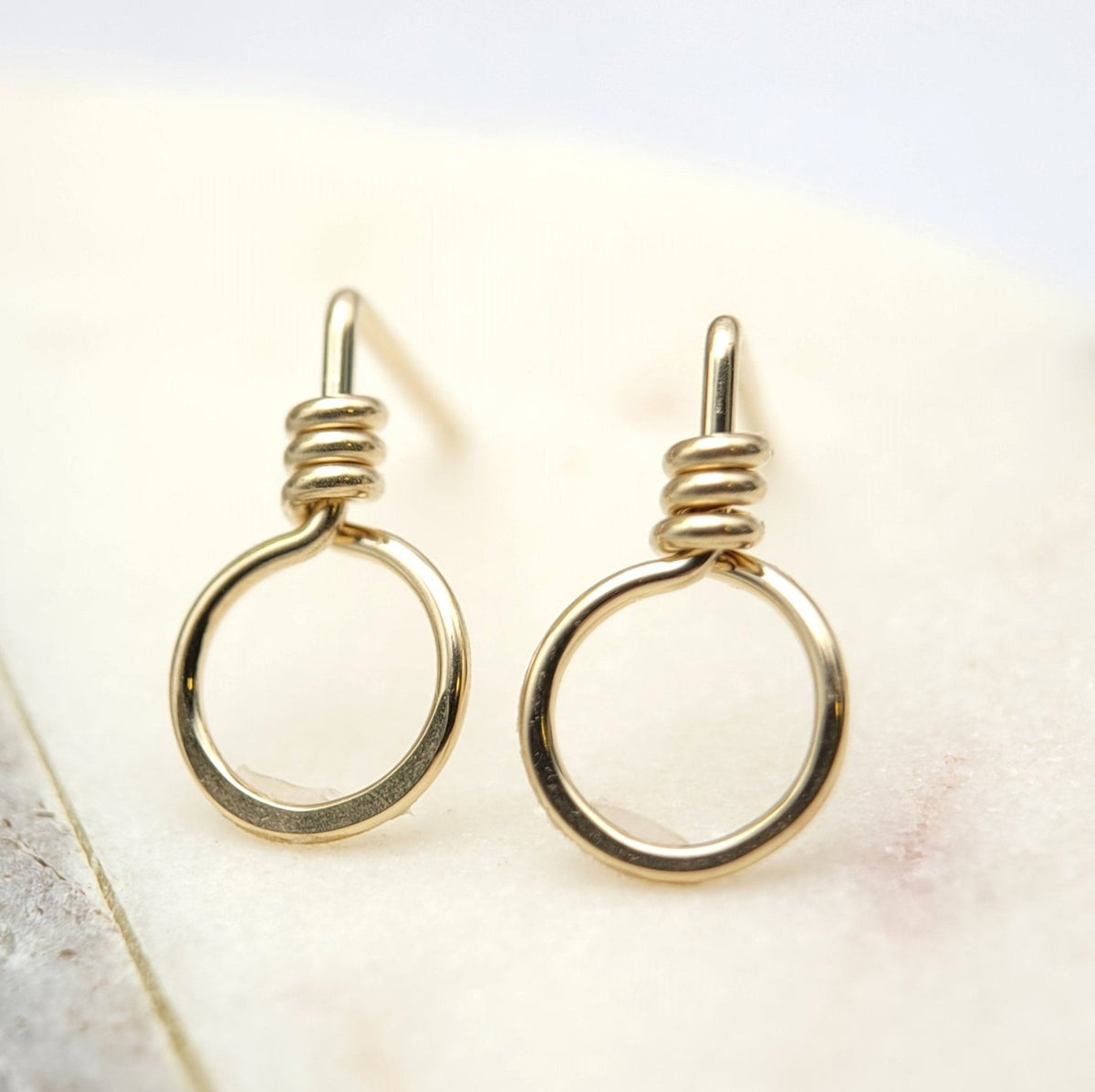 Small gold circle stud earrings from Bijou by SAM, featuring minimalist circular design perfect for everyday wear.