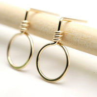 Small gold circle stud earrings from Bijou by SAM featuring minimalist design and shiny gold finish.