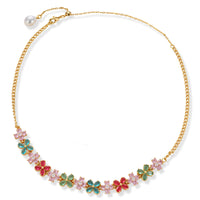 Gold-plated jewelry set with pink, turquoise and red flower-shaped cubic zirconia stones, featuring necklace, earrings and bracelet.