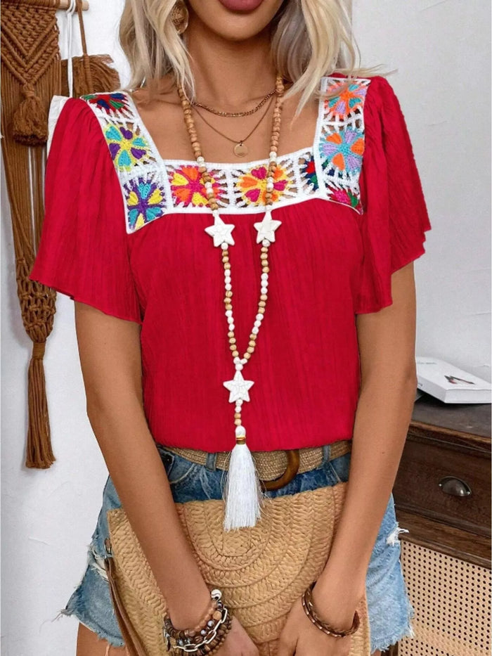 Embroidered square neck flutter sleeve blouse from Trendsi, featuring detailed embroidery and lightweight fabric, displayed on a hanger.