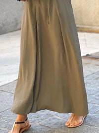Trendsi solid color maxi shirt dress with a relaxed fit and button-down front, displayed on a mannequin.