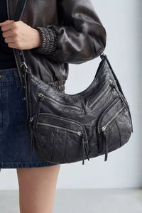 Fame Multi Zipper Pocket Leather Hobo Bag by Trendsi showing a stylish brown leather handbag with multiple zippered pockets and a slouchy design.