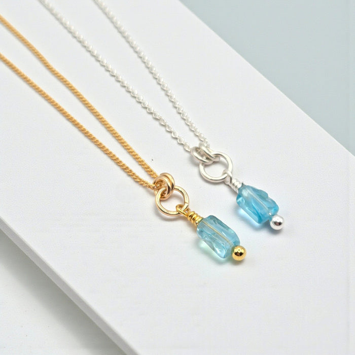 Blue Apatite necklace with silver or gold chain from Bijou by SAM, featuring a polished blue apatite gemstone pendant.