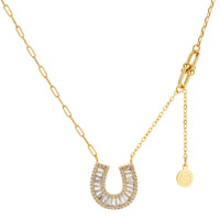 Sparkling horseshoe-shaped jewelry set with AAA cubic zirconia in gold-plated and white gold finishes on cream background.