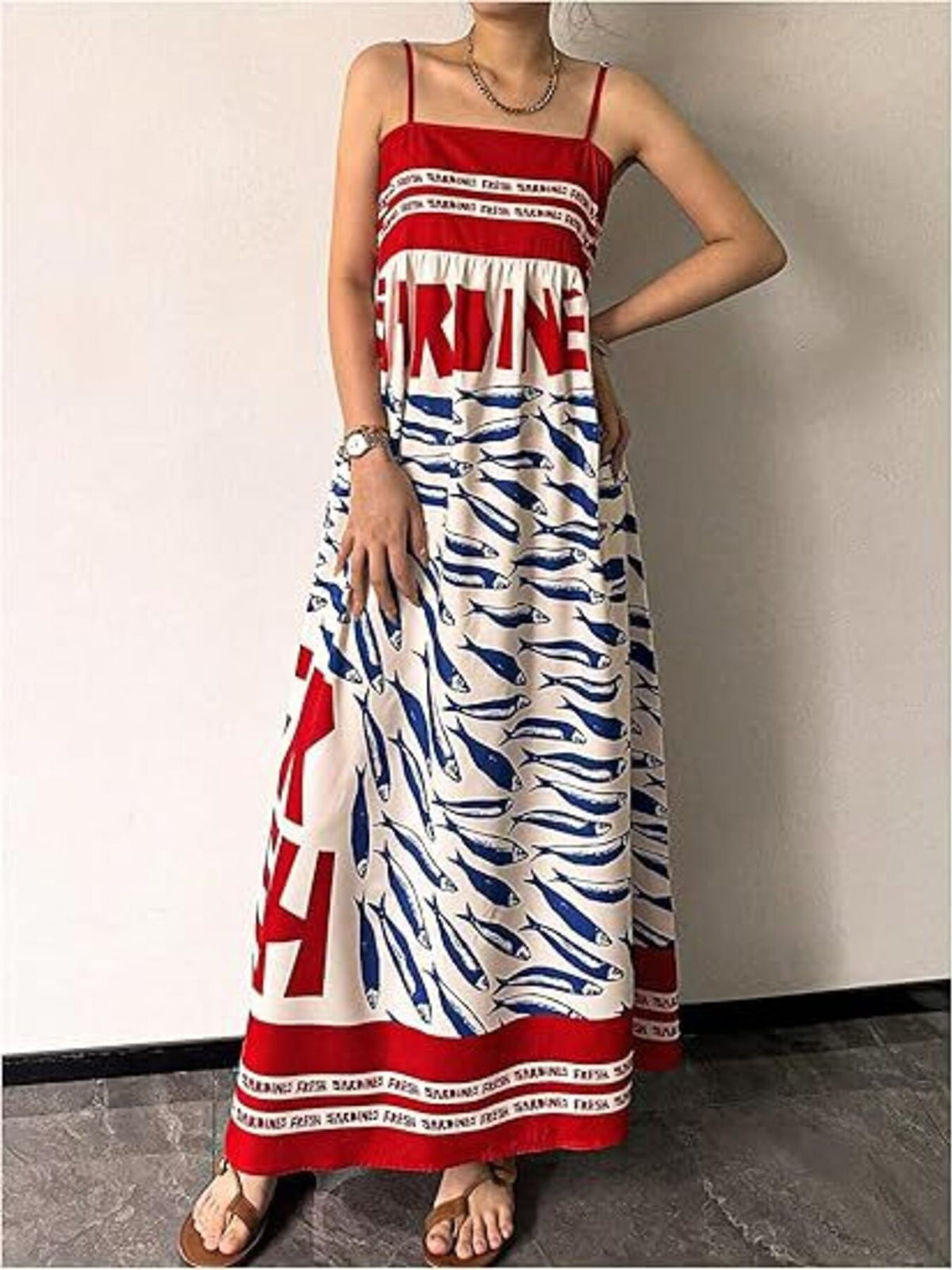 Sardine print spaghetti strap maxi dress by Trendsi featuring a flowy silhouette and bold fish pattern.