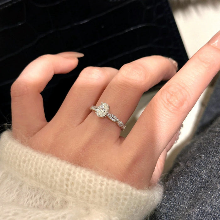 Sterling silver Éclat 1CT moissanite oval solitaire ring featuring a sparkling center stone and elegant band design.