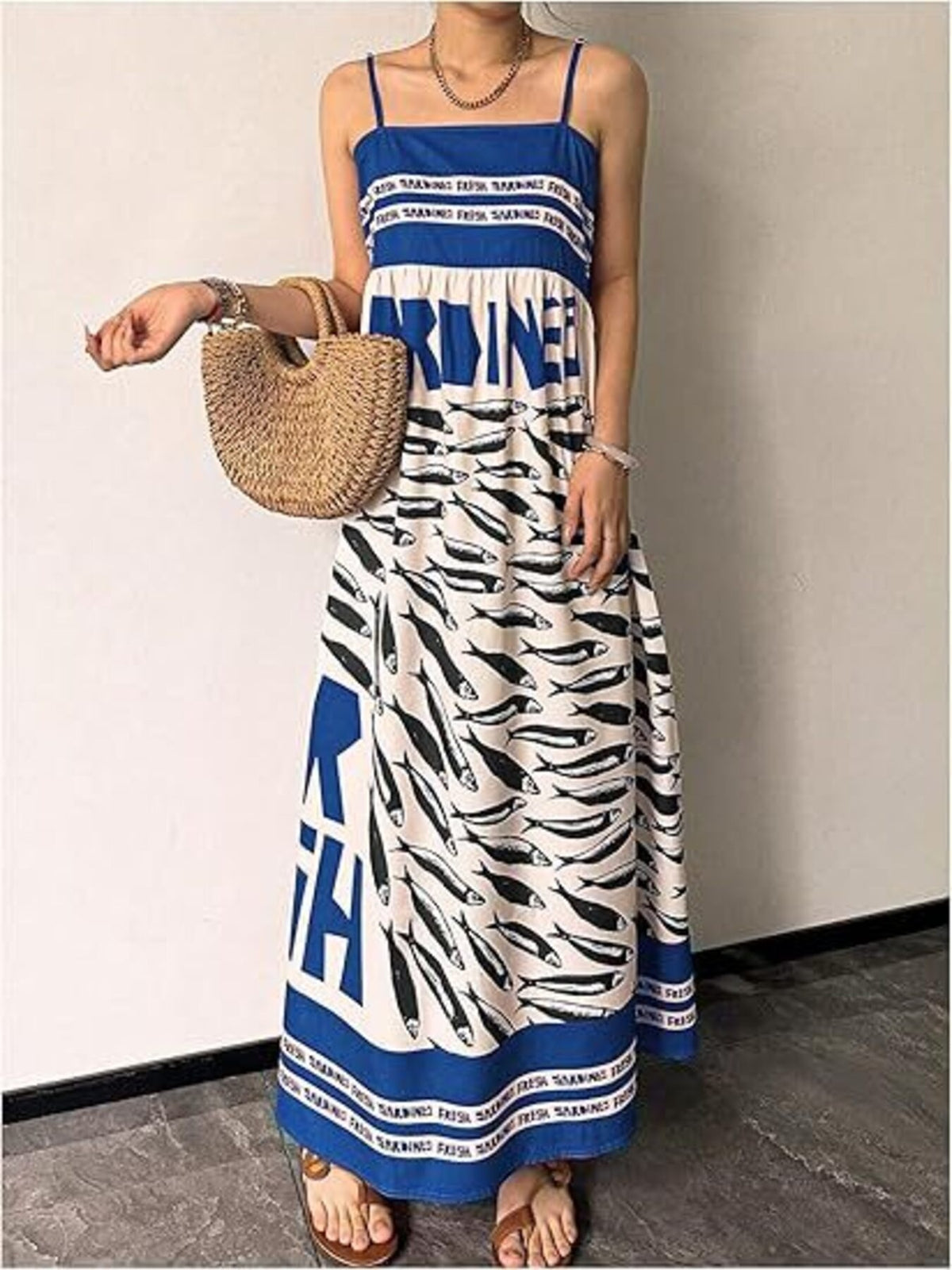 Sardine print spaghetti strap maxi dress by Trendsi featuring a flowing silhouette and stylish print for casual or summer wear.